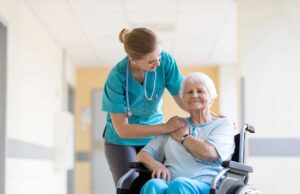 A senior arranging family photos and keepsakes on a shelf in a cozy assisted living apartment.